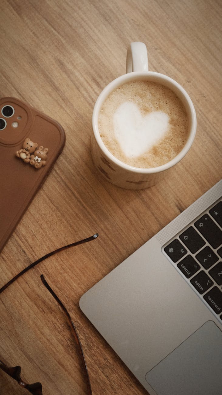 cozy workspace with latte art and laptop