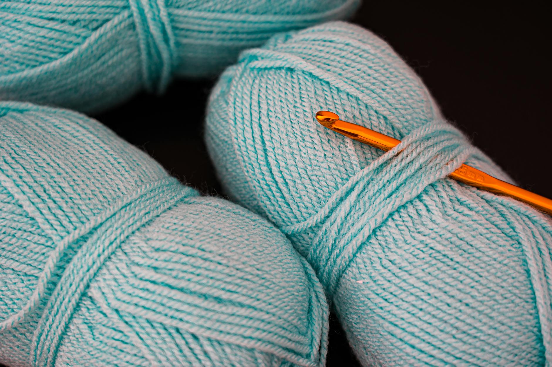 close up photo of teal yarn